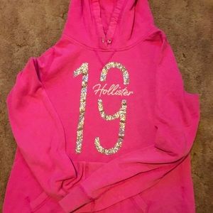 Hollister pink hoodie with #19 in glitter. No drawstring but very nice! XL Girls
